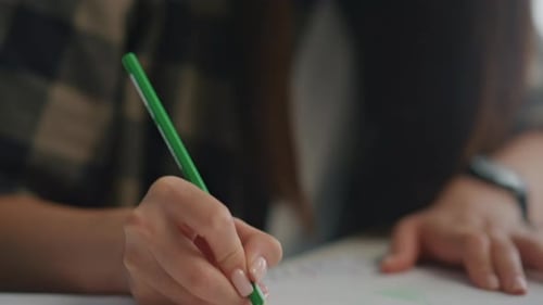 Attentive asian engineer hands drawing construction project sketch at workplace