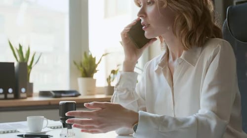 Young Caucasian Female Solicitor Consulting Client by Phone Call