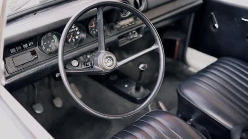 Vintage Car Interior Showing Steering Wheel and Dashboard