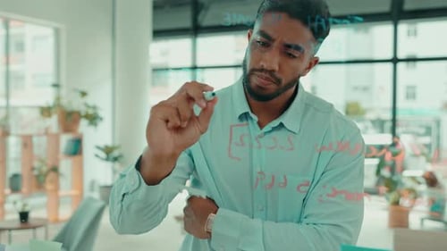 Serious man writing business notes, brainstorming agenda and target process at office window