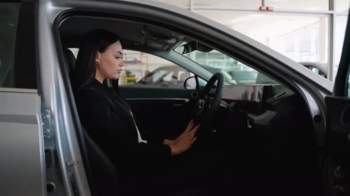 Woman Testing Horn and Airbag in New Car
