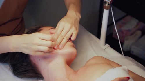 Woman Receiving Facial Massage at Spa