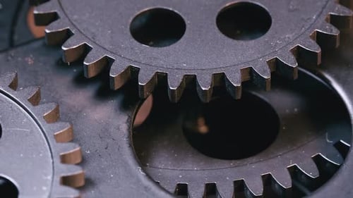 Rotating Metal Gears Interlock in a Close Up