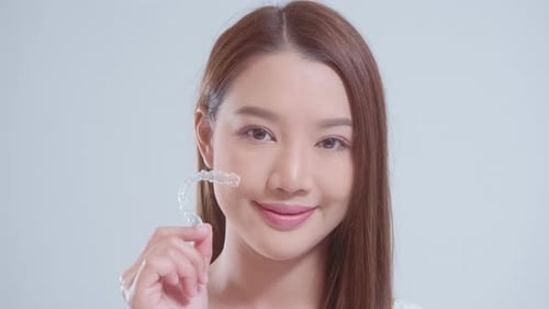 Woman Smiling with Clear Dental Aligner