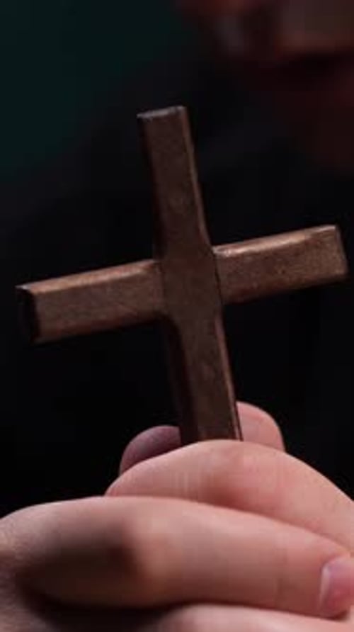 Wooden Cross Held in Praying Hands Close Up