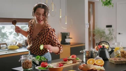 Woman Dancing While Preparing Food in Kitchen