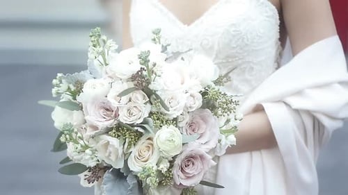 Bride Holding a Bouquet of Pink and White Roses