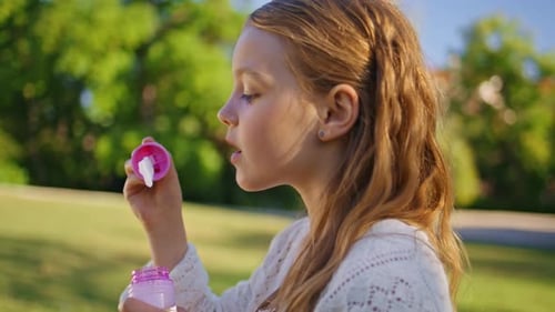 Girl Blowing Soap Bubbles in Sunny Park Portrait Cute Kid Playing in Nature