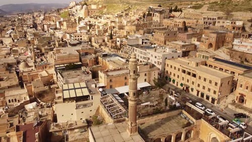 Mardin Turkey aerial pull out of old city with stone buildings and minaret
