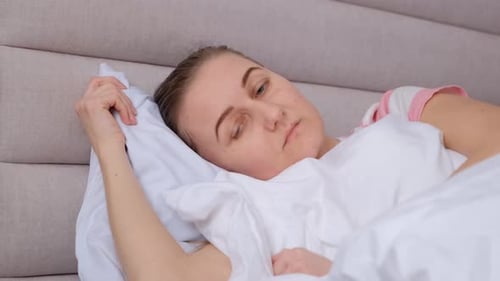 Woman Awake and Restless in Bed