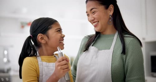 Mother and Daughter Baking Together in the Kitchen