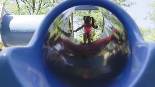Little Girl Swinging Joyfully on the Playground Set