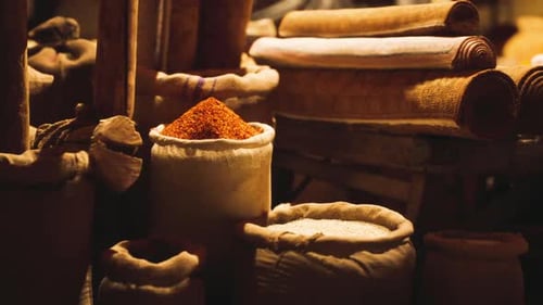 Traditional Market Stall with Spices and Rolled Textiles