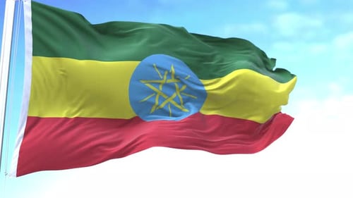 Realistic Ethiopia Flag Waving on a Pole Against Blue Sky