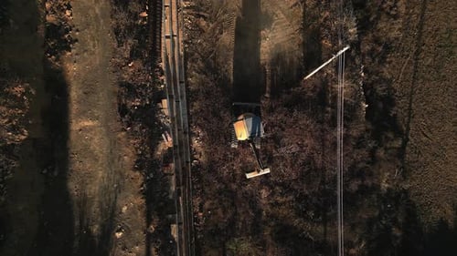Aerial top down view of an excavator in sunset