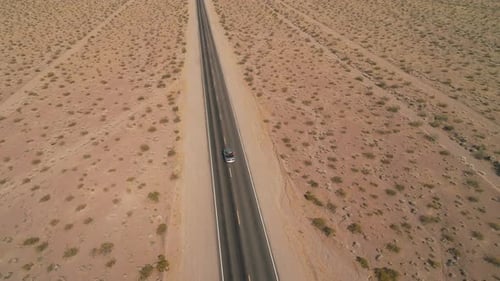 High Aerial View of Car on Desert Road