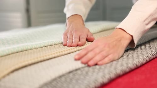 Close up of Hands Examining Fabric Samples
