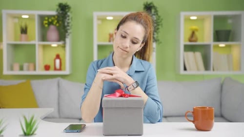 Woman Unsure About Opening a Gift