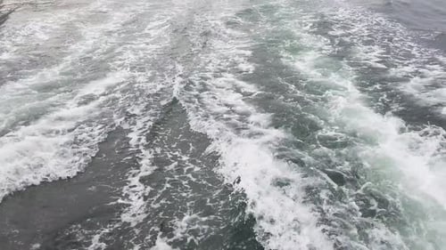 Waves From A Large Ferry Boat Sailing Across The Ocean. - Tracking Shot