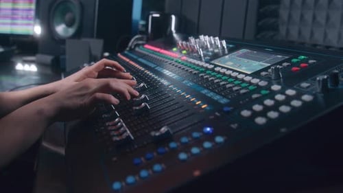 Audio Engineer Uses Mixing Console in Recording Studio
