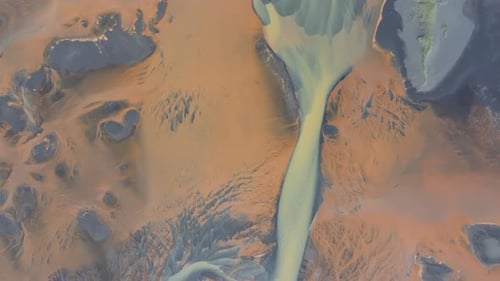 Aerial video over YELLOW RIVER and flowing glaciers in Iceland landscape