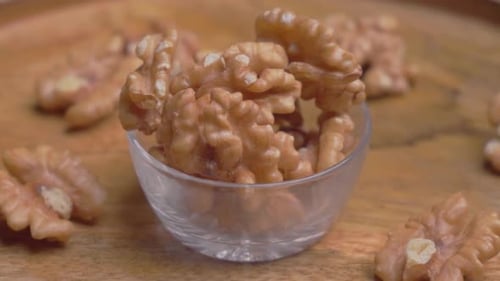 Walnuts in Bowl on Wood Close Up