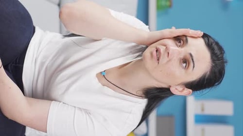 Woman Experiencing Headache and Neck Pain at Home