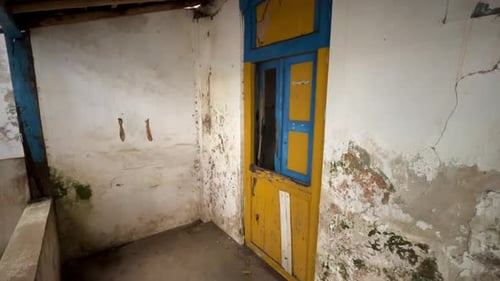 Open window of old house. Spooky scene from empty damaged old house. The terrace of an damaged old h