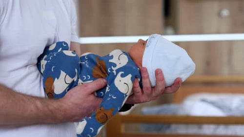 Dad Holding a Newborn Baby