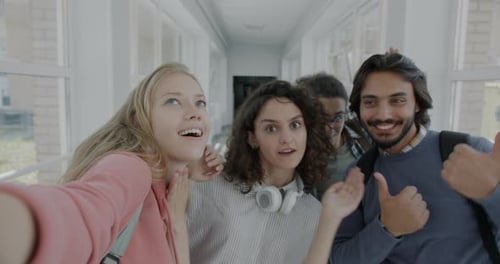 Group of Students Taking Selfie Posing Looking at Camera Laughing Having Fun in University Hall