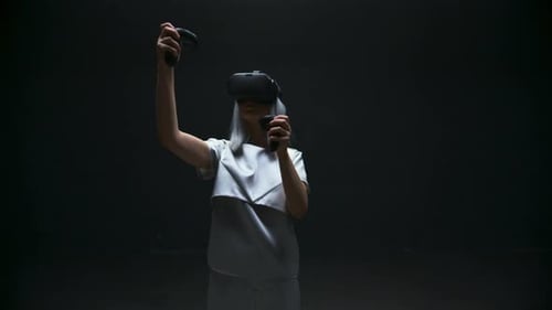 Woman Using Virtual Reality Headset and Controllers