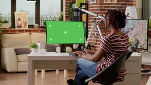 Woman Working on Green Screen Computer in Home Office
