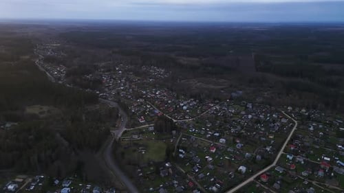 an Aerial View of a Small Town in the Middle of a Forest