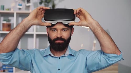 Man Wearing VR Headset Indoors Experiencing Virtual Reality
