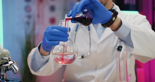 Scientist Conducts Experiment with Red Liquid in Laboratory