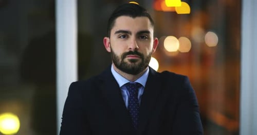 Face, confidence and business man in office, corporate company or workplace at night