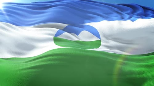 Waving Flag with Stylized Mountain Symbol Against Blue Sky