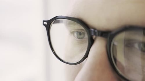 Man Eyes in Eyeglasses Looking Intently Forward Isolated on White Close Up