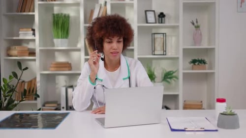 Young Doctor in Video Conference Using Laptop