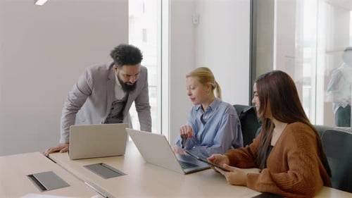 A Diverse Team Working Together in a Modern Innovative Office Environment to Achieve Success