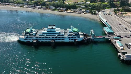 Drone shot of cars driving onto a Washington State ferry.