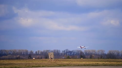 White little plane is rising in the air. Aircraft is flying above the field in autumn.