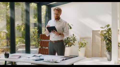 Designer Standing in Studio and Drawing on Digital Tablet