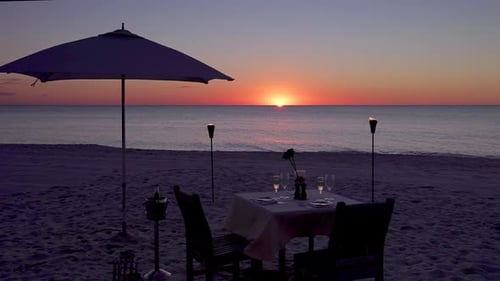 Romantic Table on the Beach Set for Two at Sunset, Tracking