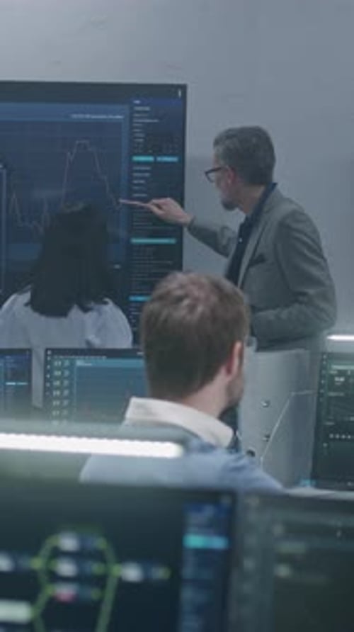 Scientist Analyzes Charts with Female Colleague