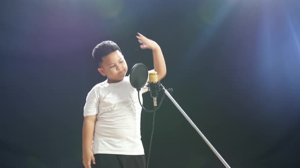 Young Asian Boy Rapping Into A Condenser Microphone On The Black ...