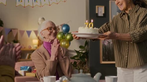 Seniors Celebrating Birthday with Cake and Tea