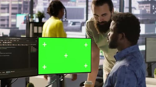 Team of IT Workers Using Green Screen Computer