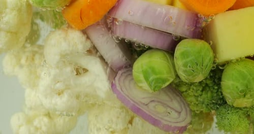 Vegetable mix for making soup in boiling water with air bubbles.