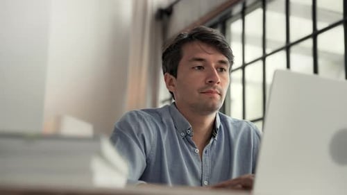 Business Man Working in Home Office and Typing on Keyboard of Laptop Computer